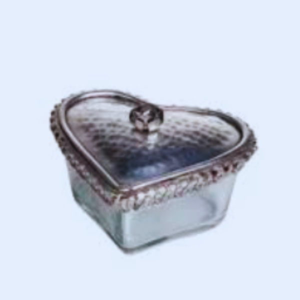 Heart-shaped glass container with a lid on a light blue background