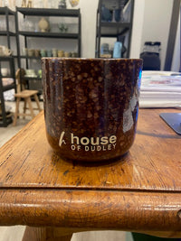 Thumbnail for Ceramic mug with 'House of Dudley' branding on a wooden surface.