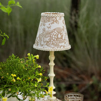 Thumbnail for Luxe & Beau gold toile lamp shade on a cream lamp base in a garden setting – alternate view