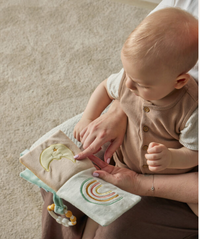 Thumbnail for Baby reading the sage green teddy bear activity fabric book