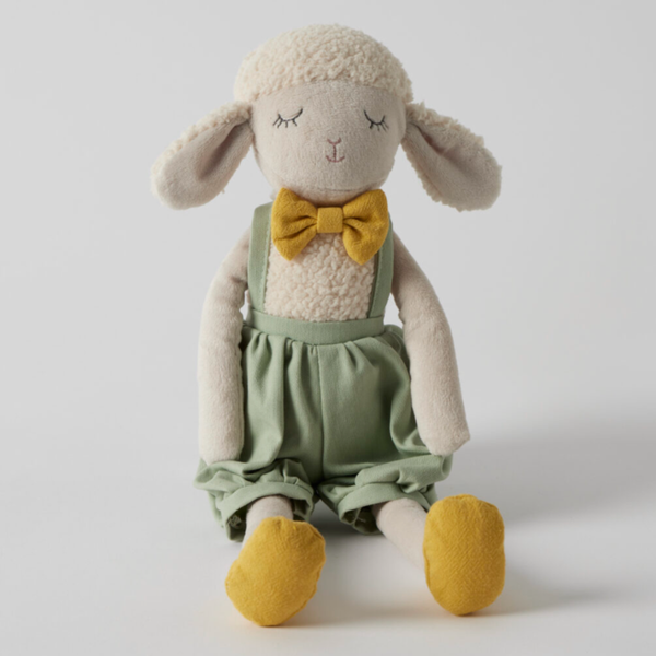 Stanley plush sheep soft toy with a cream fleece body, dressed in a sage green outfit with mustard shoes