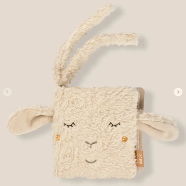 Ecru organic cotton sheep soft baby book, front cover with stitched sheep face