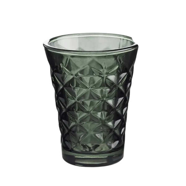 Green textured glass tumbler on a white background