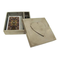 Thumbnail for Beige jewelry box with heart design on lid, containing a card and small item.