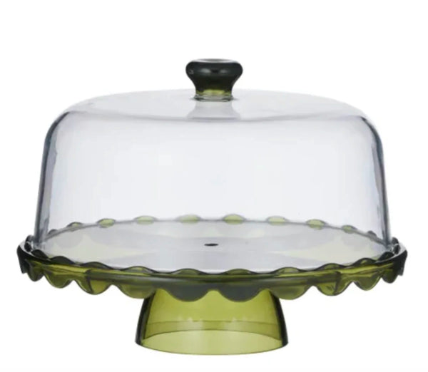 Green glass cake stand with a clear dome lid on a white background