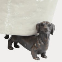 Thumbnail for Antique bronze resin dachshund pot stand supporting a white planter, close-up