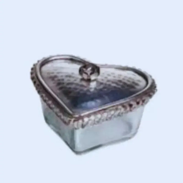 Heart-shaped glass container with a lid on a light blue background
