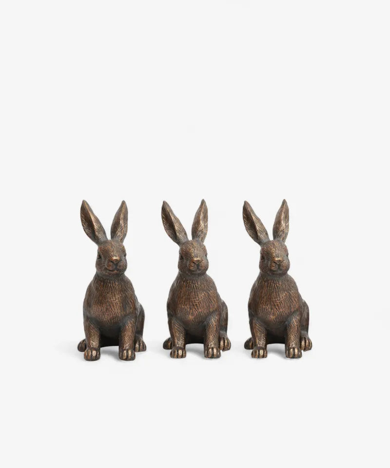 Set of three brass-finish resin hare pot stands, alternate view