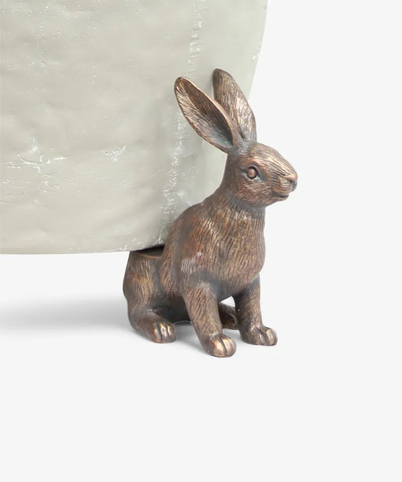 Provincial hare pot stand in brass-finish resin, single hare supporting a pot