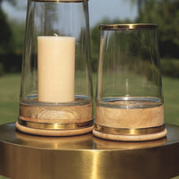 Thumbnail for Glass hurricane candle holders with brass bands and turned wood bases, small and large shown together