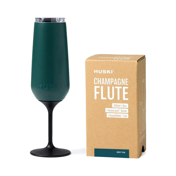 Huski Champagne Flute in Deep Teal with black TwistLock stem and clear lid, beside its kraft gift box | House of Dudley