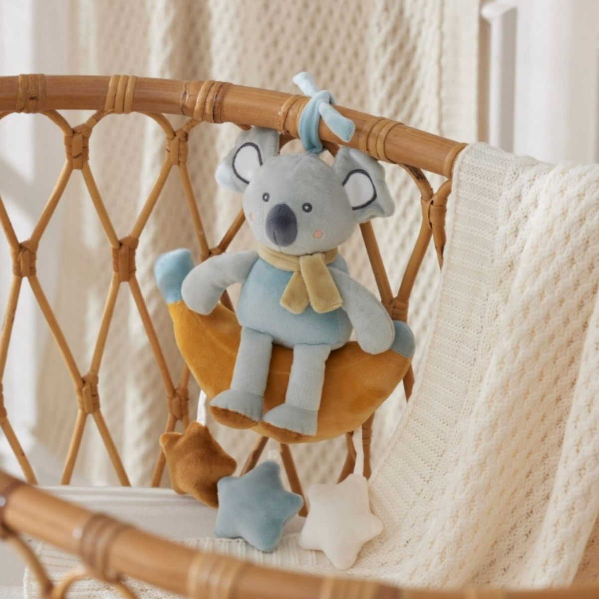 Musical plush koala on a banana, alternate view showing the star detail and pull cord
