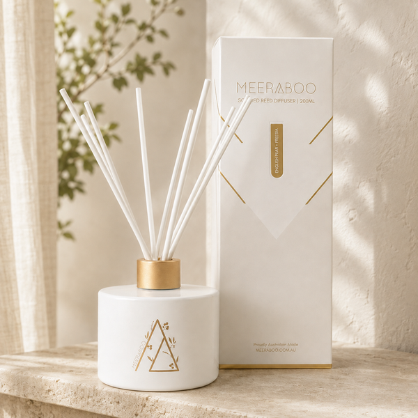 Meeraboo Scented Reed Diffuser 200ml in matte white glass with gold foil detail, beside its gold-foiled gift box