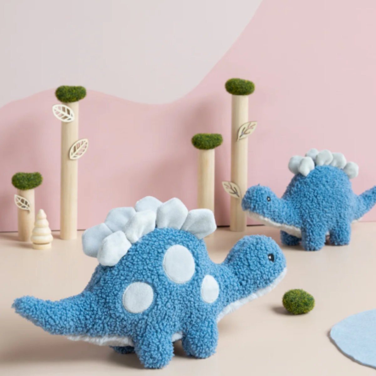 Stu the Stegosaurus blue soft toy styled on a shelf – alternate view