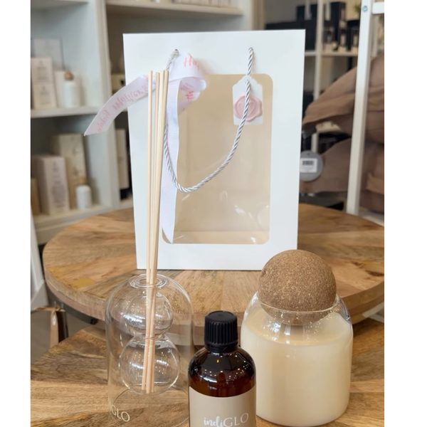 Aromatherapy diffuser with a bottle and a ball on a wooden table.